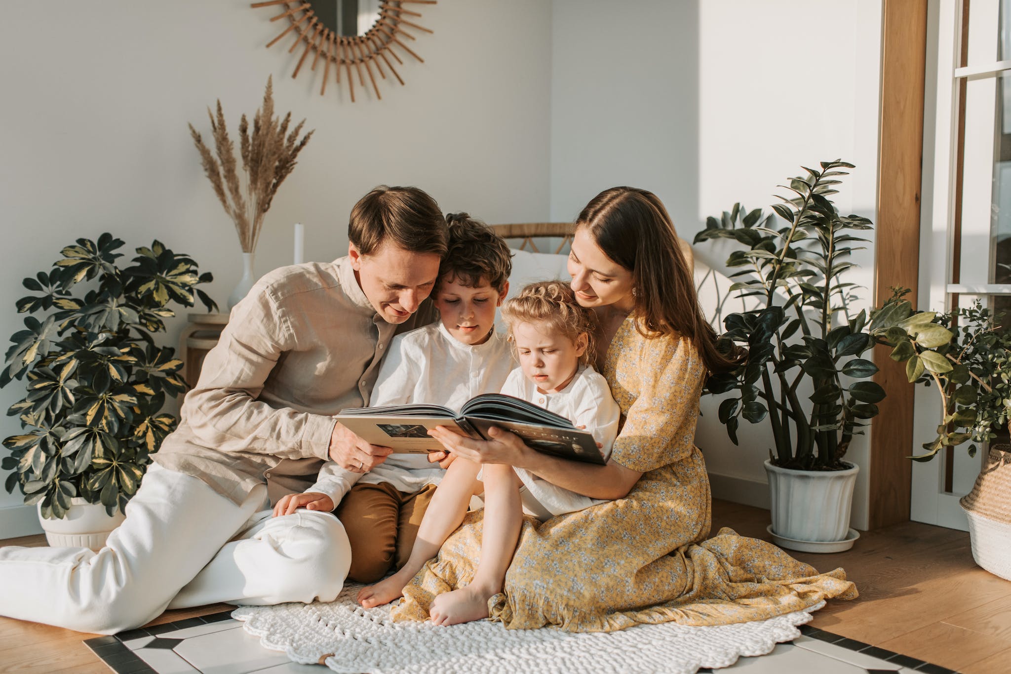 Family sitting and reading life story book together