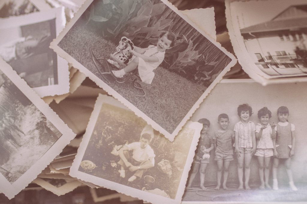 Old Photos scattered on a table ready to sort and add to their stories